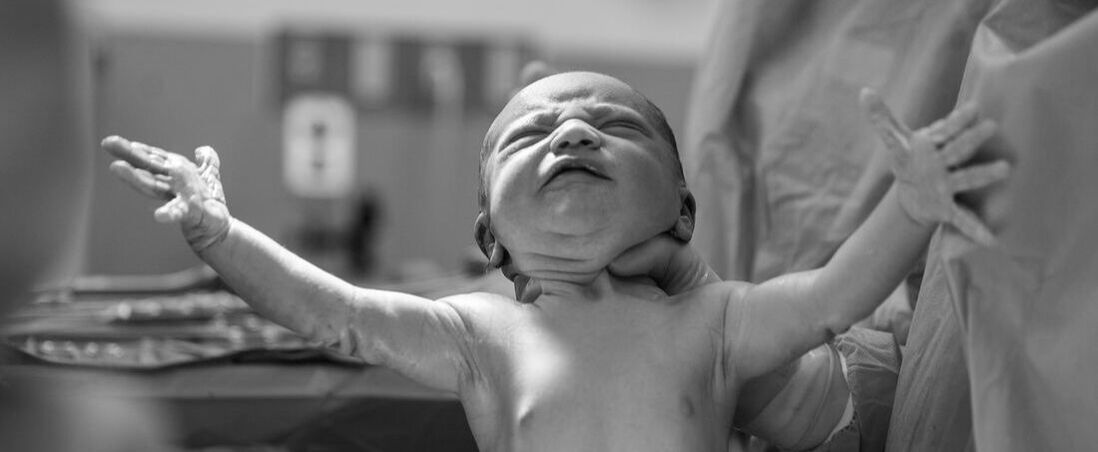 Newborn baby with outstretched arms