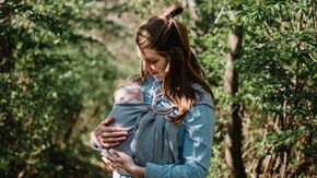 New mom with newborn baby in carrier